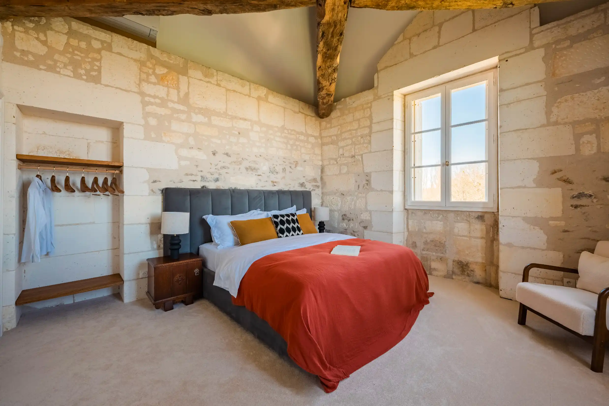 Colonial-themed bedroom with a desk, chair, and small open wardrobe
