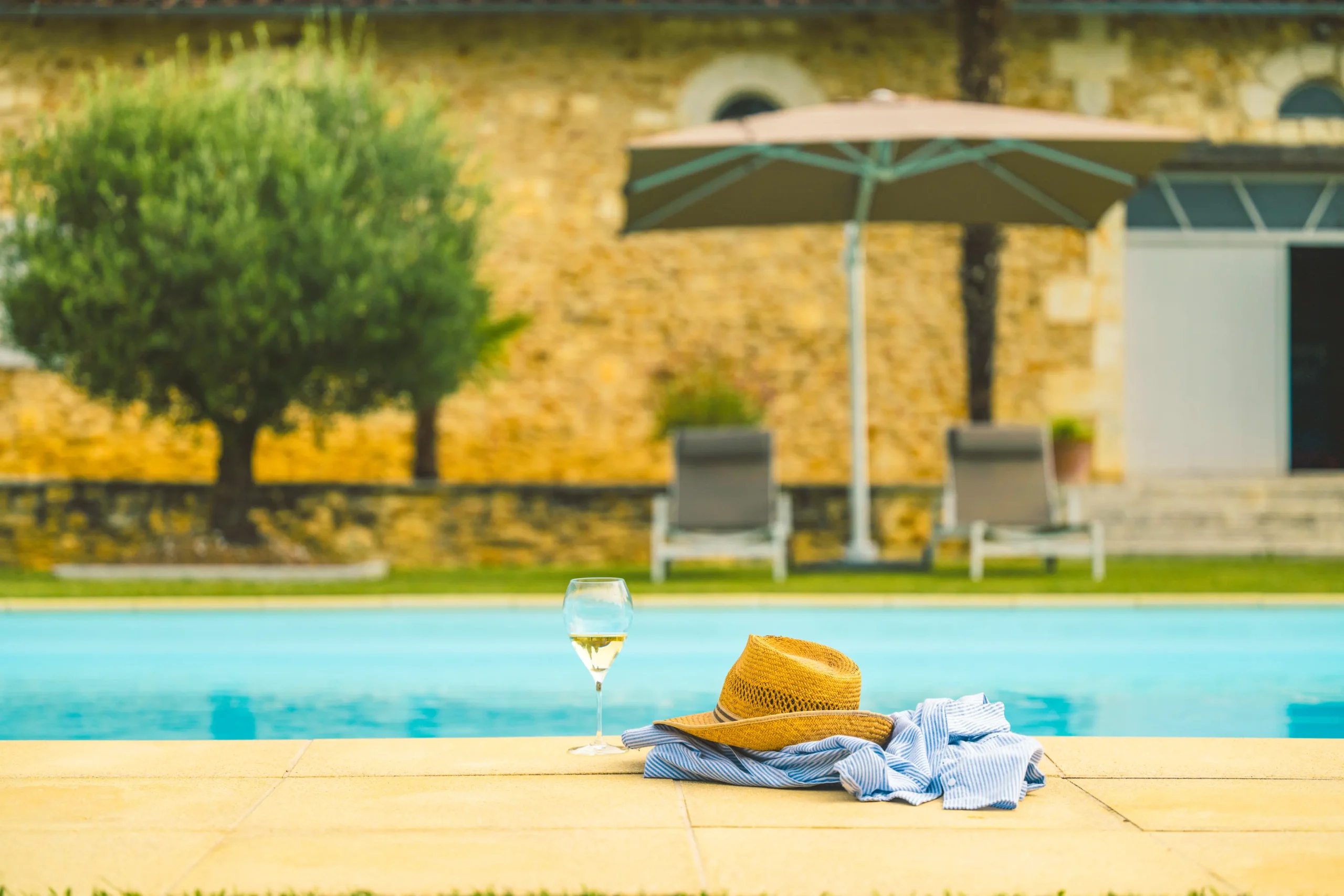 Refreshing pool with a wine bottle and glass on the edge