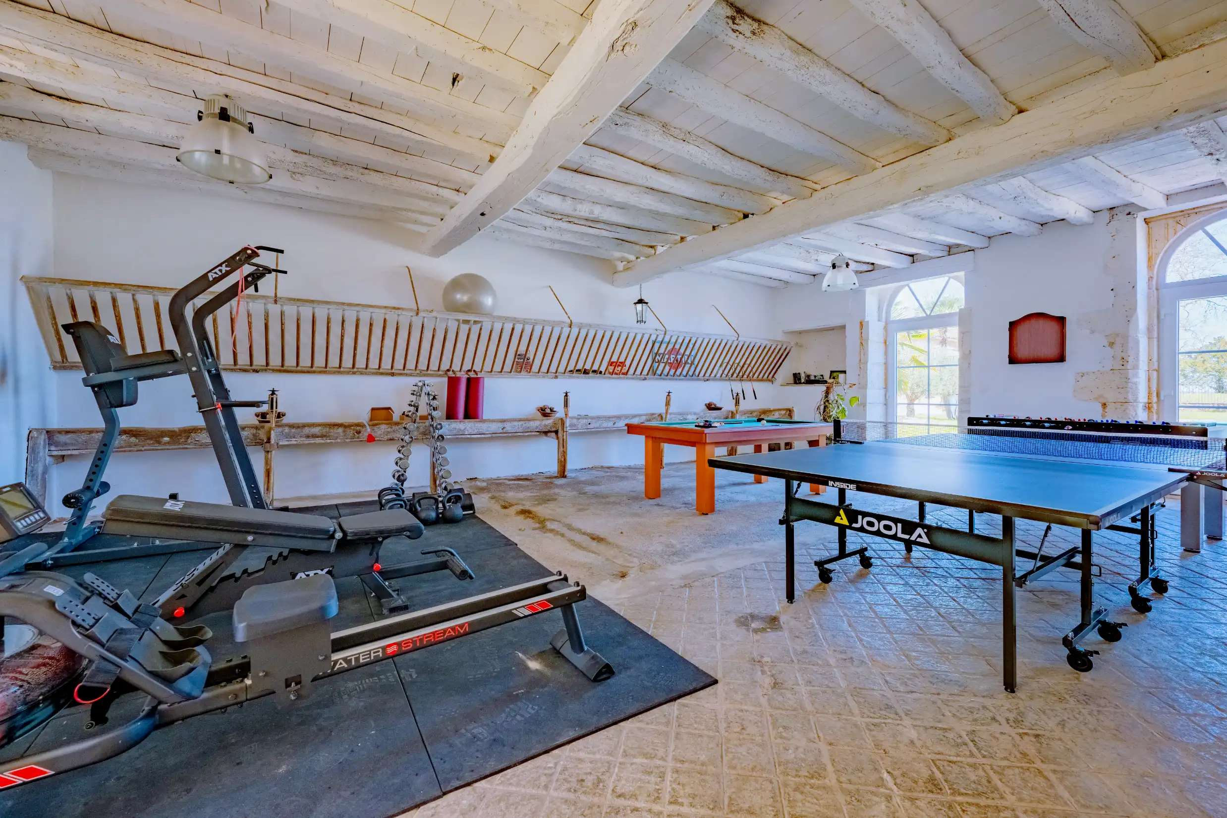 Wide view of a games room featuring multiple game tables and a well-lit interior