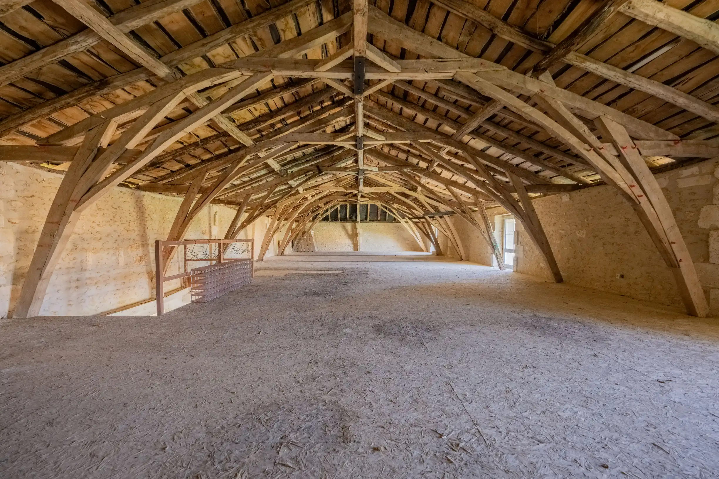 Open attic space with wooden beams and rustic charm
