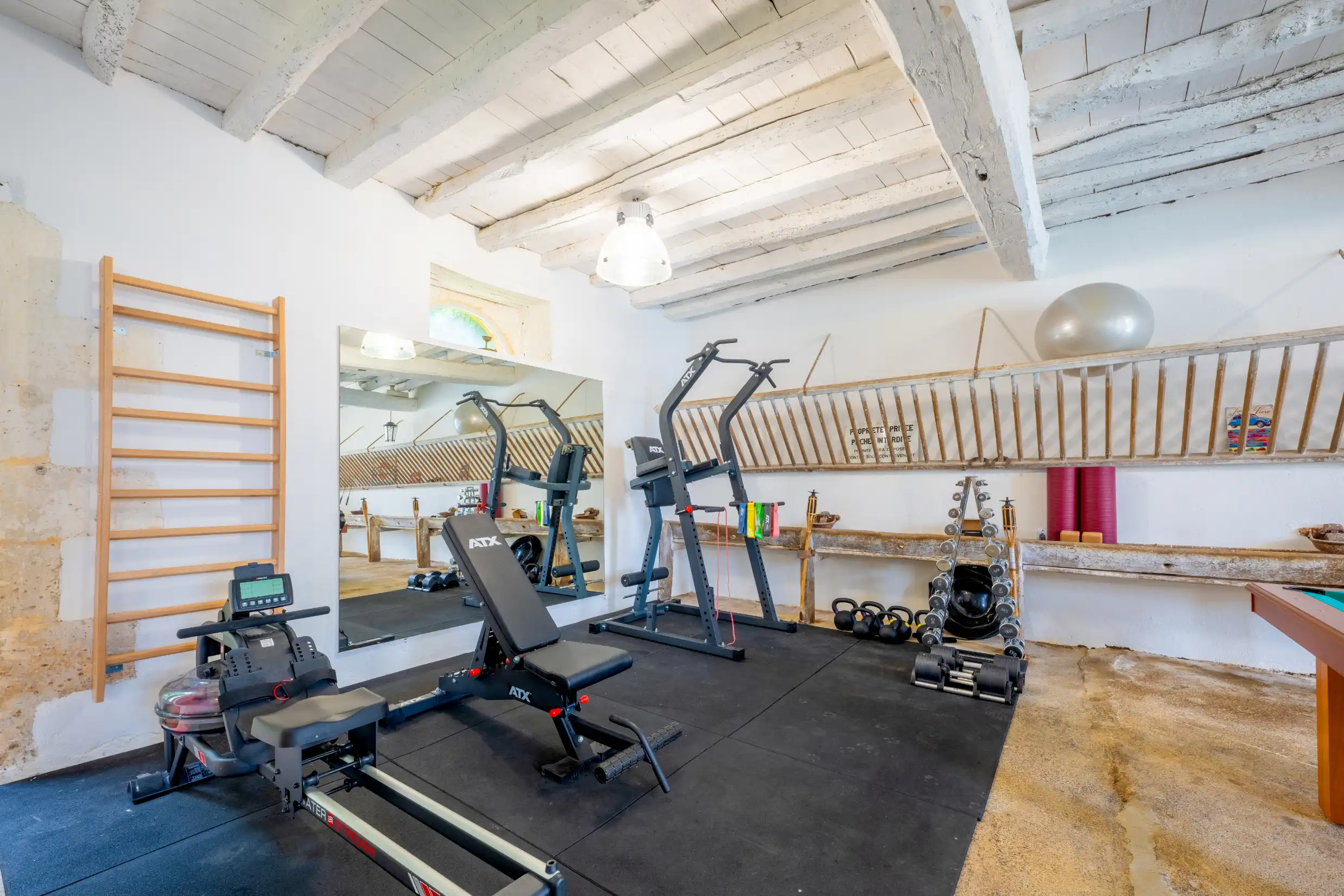 Gym area with workout equipment, including weights and machines