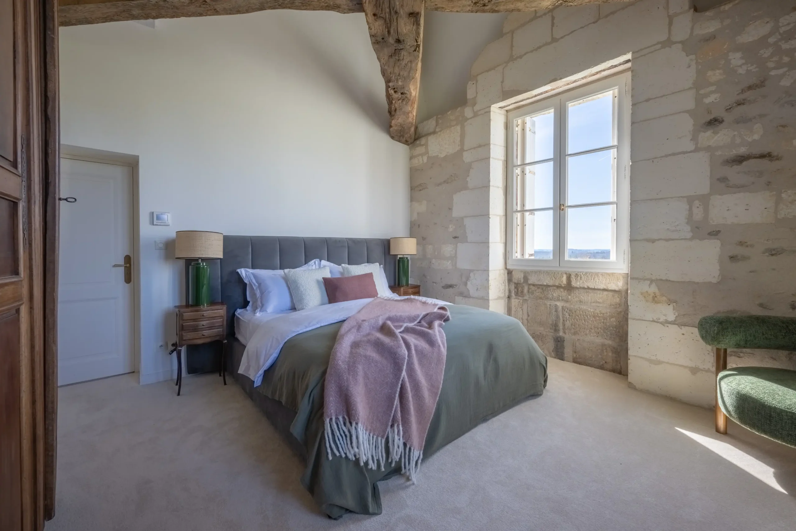 Vibrant living room with yellow walls, red sofas, and modern decor in a French castle