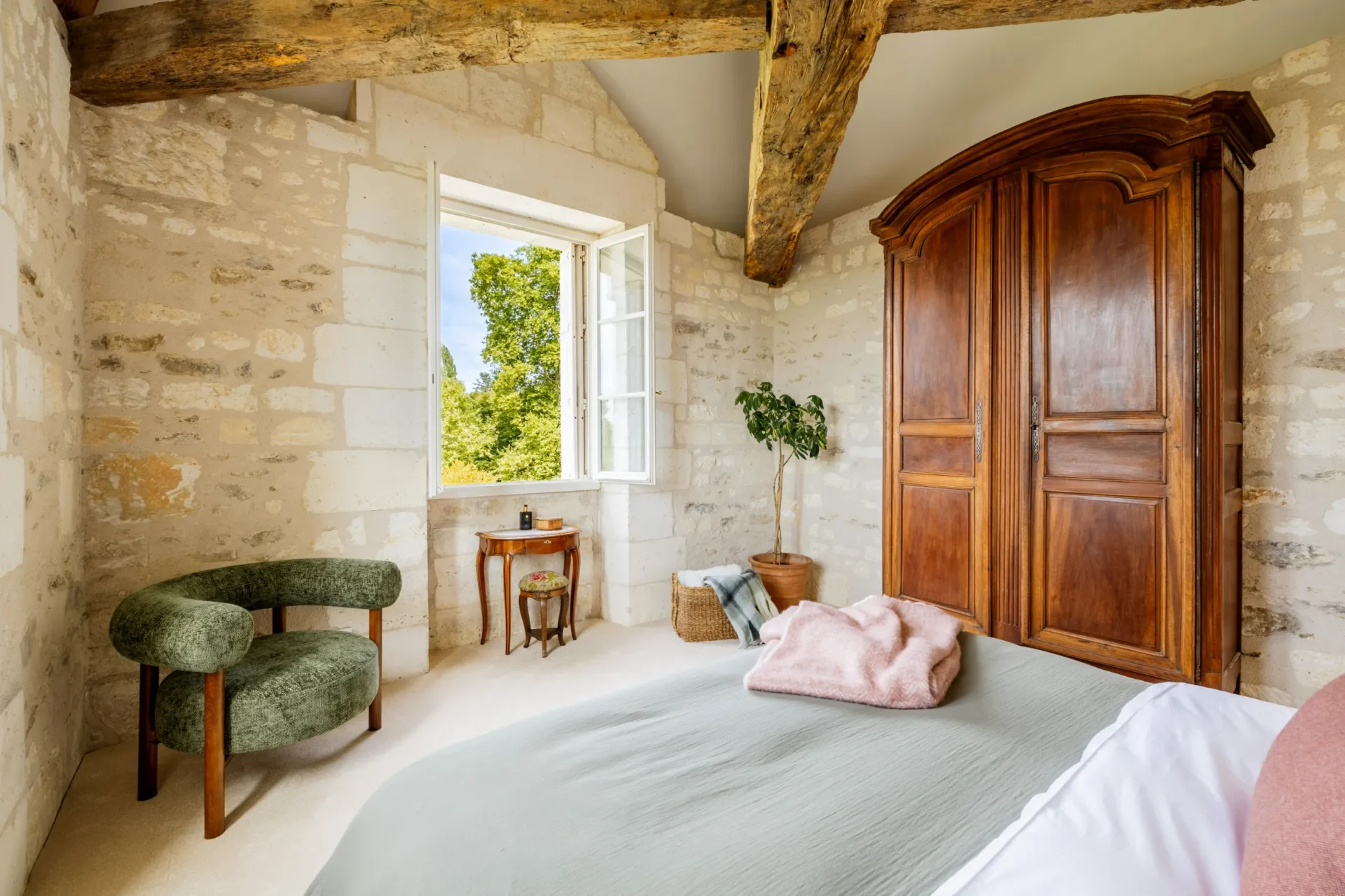 Spacious bedroom with natural light and garden view
