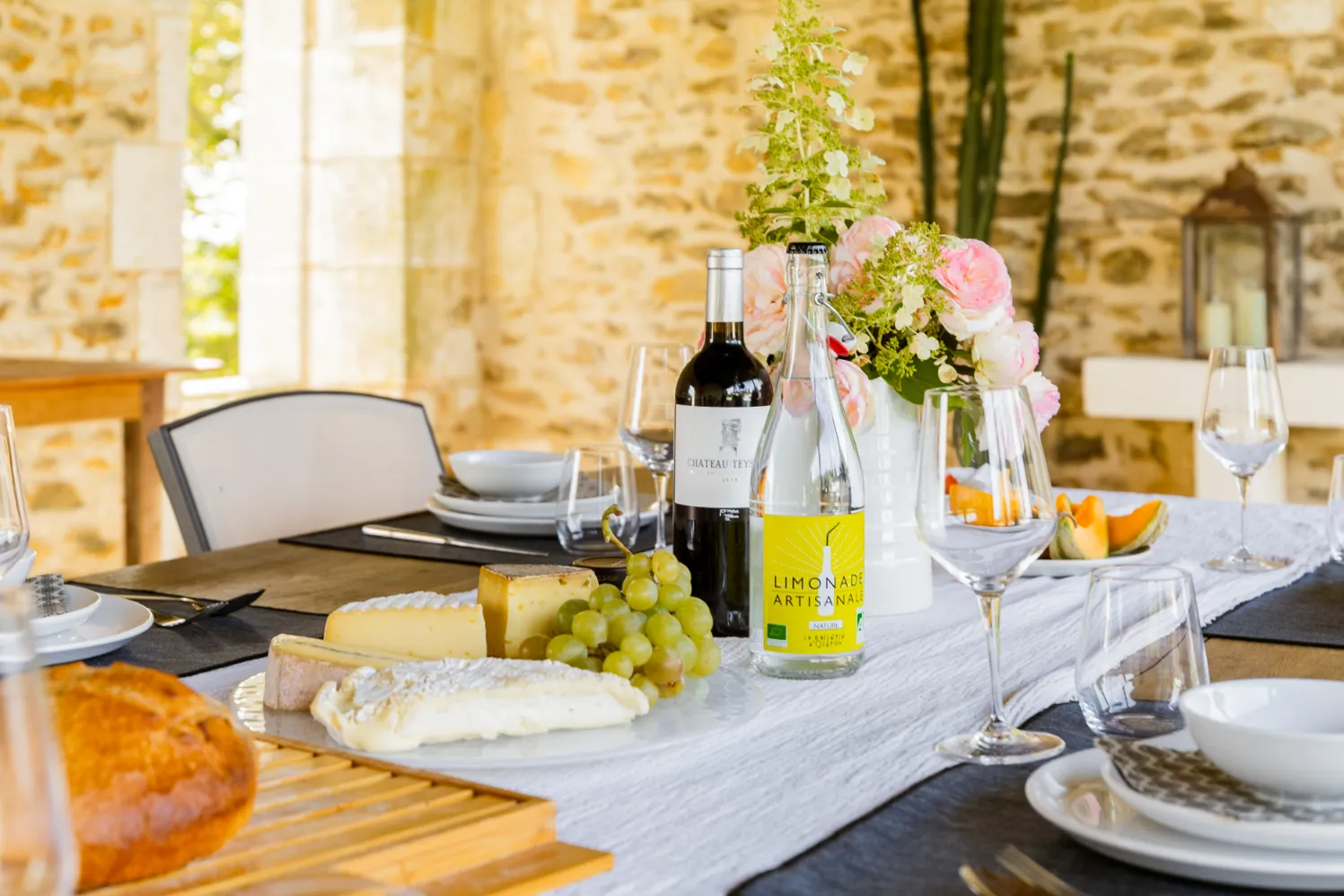 Elegant dining table with wine, cheese, and fresh grapes