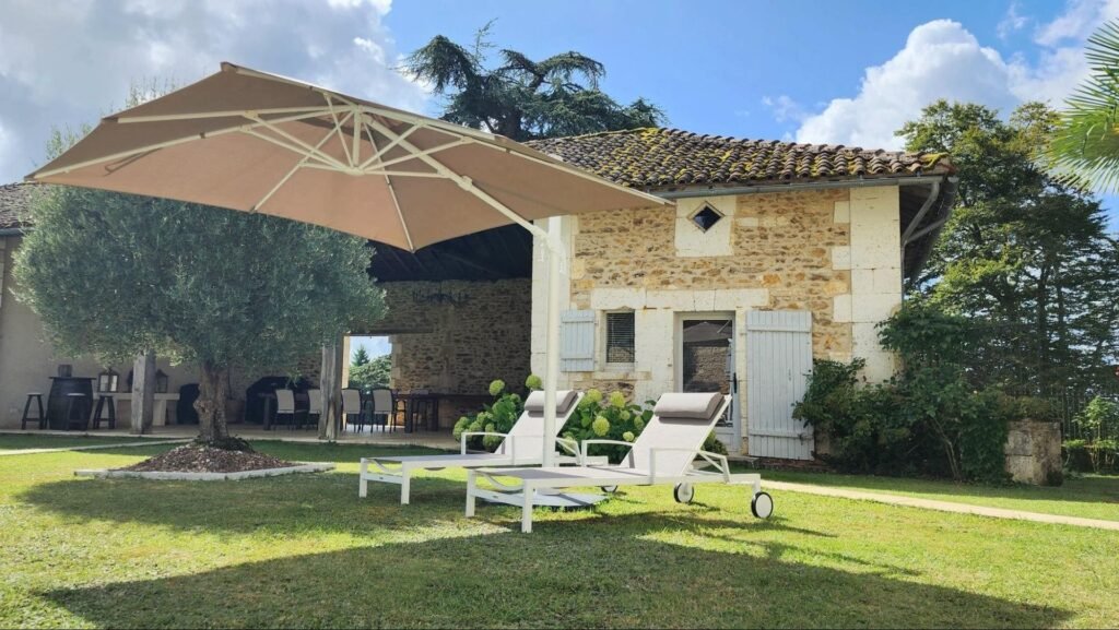 Photo at Château de Lasfonds. Garden lounge area for a French chateau wedding.