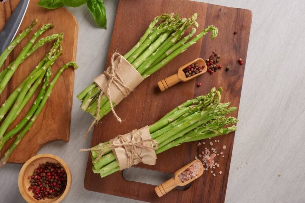 Banches of fresh green asparagus on wooden surface
