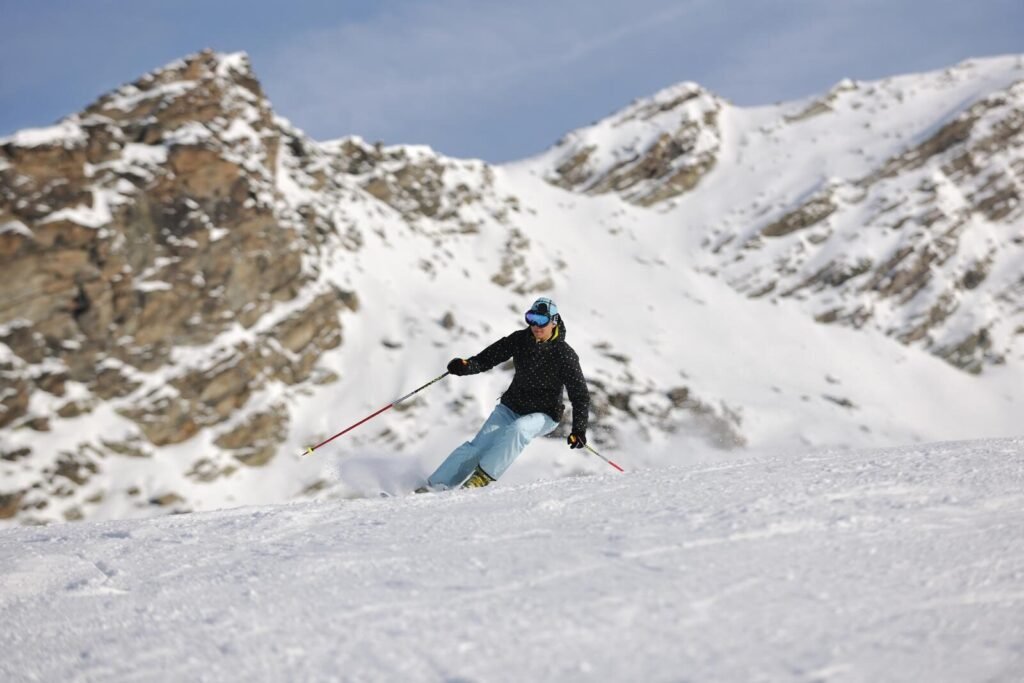 woman skiing on fresh snow at winter season in france alps