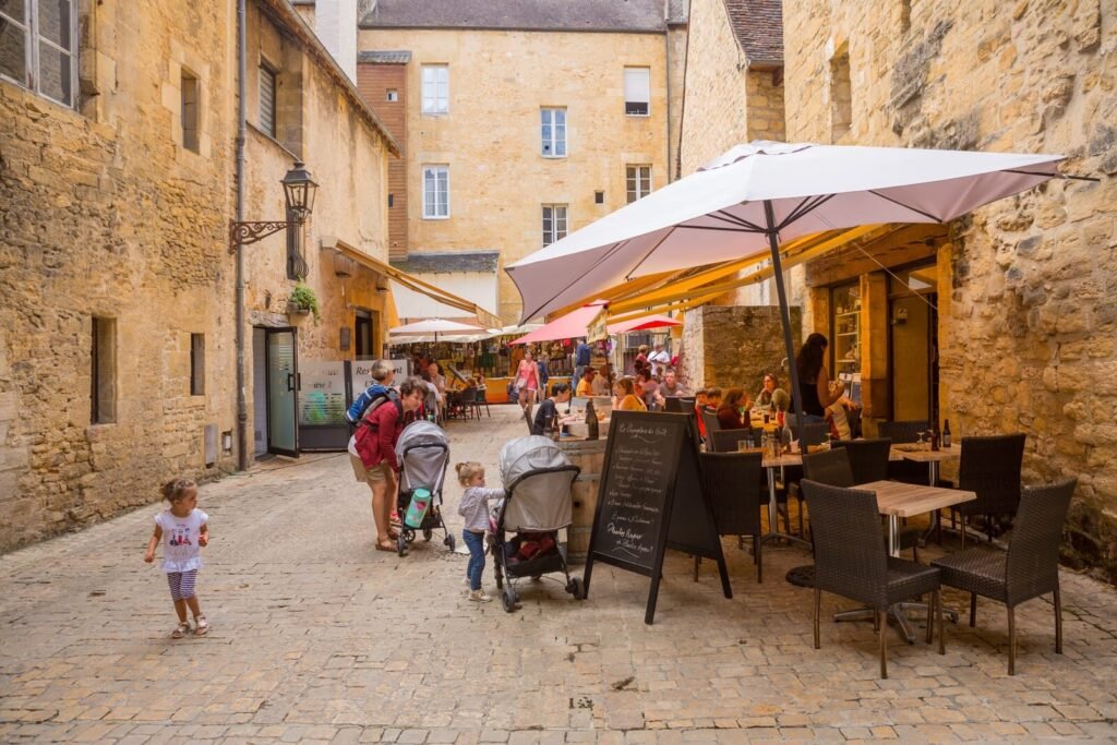 People enjoying the view of the centre of the old medieval town of Sarlat-la-Caneda, Dordogne.