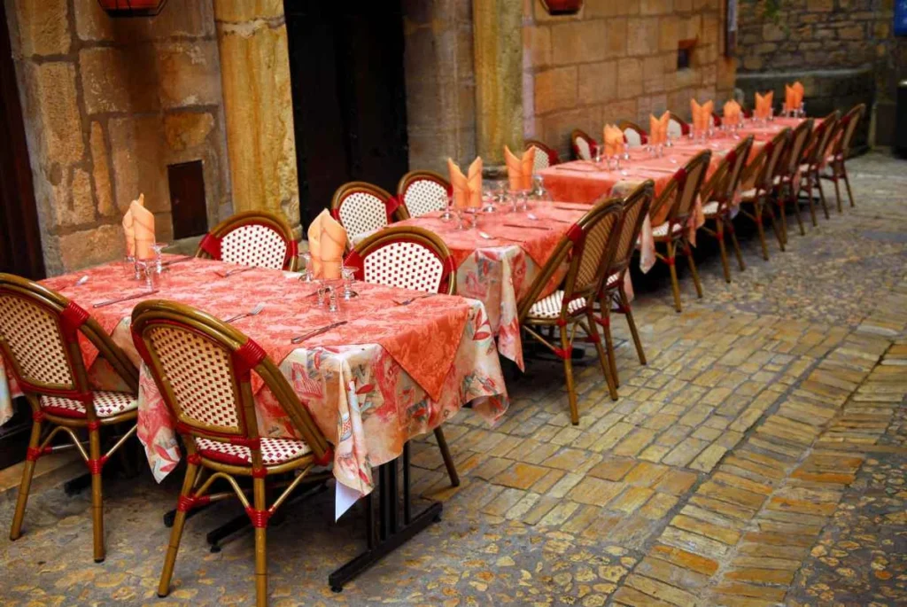 Outdoor restaurant patio on a medieval street of Sarlat